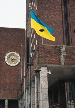 Exterior of city council hall with flag on wall in daylight