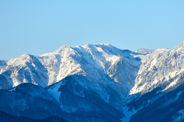 Fototapeta na wymiar K2. Sherpa. Mountain with snow and lake. Picturesque winter. Trees reflected in a calm alpine lake. Mountain. Tragedy on K2. A sherpa dies climbing K2. Climbers. Karakoram mountain range. Himalayas.