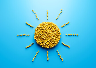 3d Unique Sun With Rays Symbol Made Of Yellow Plastic Polymers Sea Blue Background 3d Illustration