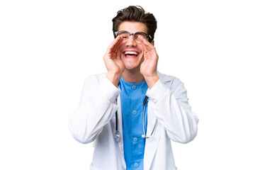 Young doctor man over isolated background shouting and announcing something