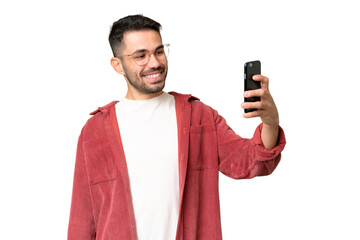 Young handsome caucasian man over isolated chroma key background making a selfie
