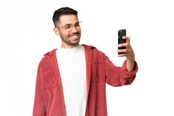 Young handsome caucasian man over isolated chroma key background making a selfie