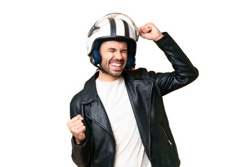Young caucasian man with a motorcycle helmet over isolated chroma key background celebrating a victory