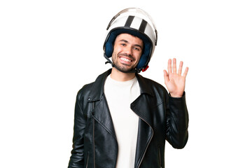 Young caucasian man with a motorcycle helmet over isolated chroma key background saluting with hand with happy expression