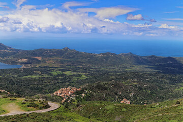 Naklejka premium High angle view from Col de la Bataille of Speloncato, typical north Corsican village in Balagne, with plaine du Reginu and Ile Rousse and sea in the Background