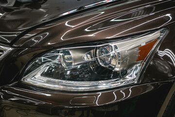 Fototapeta premium Modern Car exterior details.Headlight of a modern sport car close-up. 