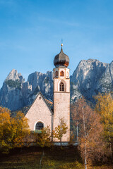 Fototapeta na wymiar Bright photo of St. Constantine church in Dolomites, Trentino Alto Adige Italy