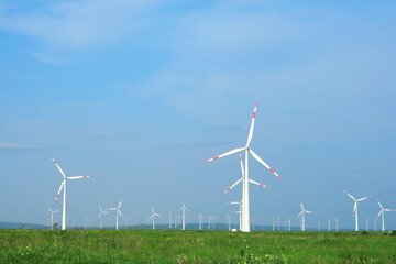 Wind turbines and agricultural fields on a summer day. Energy Production with clean and Renewable Energy