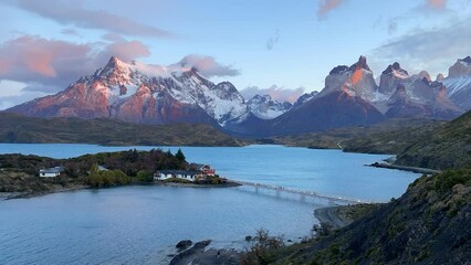 Beautiful scenery view in Torres del Paine National Park with lago pehoe lake in the middle during sunrise time, Patagonia, Chile.	Movement of clouds, sunshine and water surface from strong winds