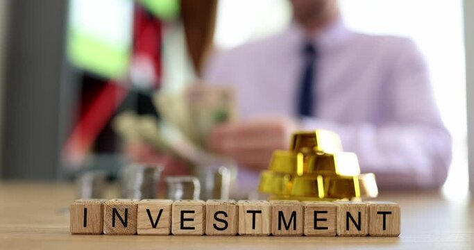 Bars of pure gold businessperson counts dollars and investment text. Financial income cash contribution and money interest growth