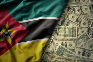 colorful waving national flag of mozambique on a american dollar money background. finance concept