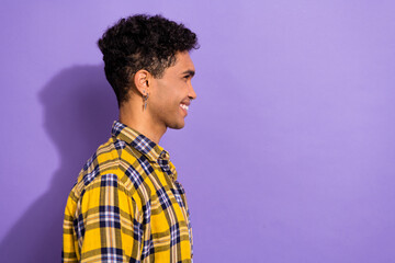 Fototapeta na wymiar Photo of cool positive guy wear plaid yellow shirt looking empty space isolated violet color background
