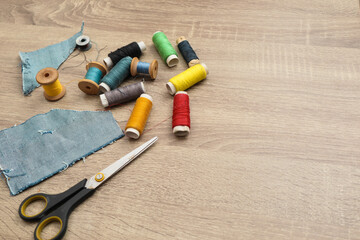 Scissors and sewing supplies on desk. Directly above shot of sewing items on wooden background