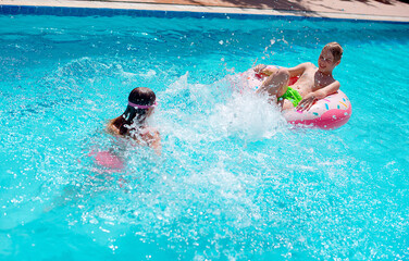 kids dive in the swimming pool and have fun