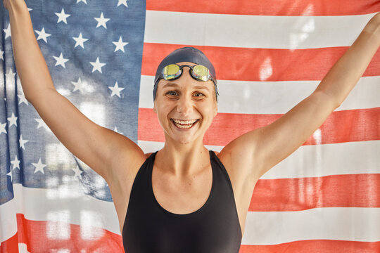 Woman, sport and flag for USA in portrait for winning, goals and pride for swimming games. Girl, swimmer or athlete with smile on face for contest, race or happy for fitness, health or United States - Powered by Adobe