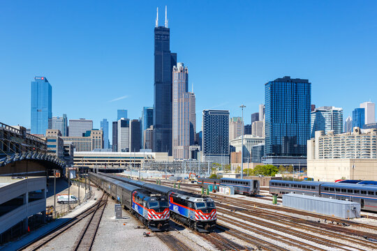 Skyline with METRA commuter rail trains public transport near Union Station in Chicago, United States