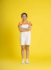 cute asian girl posing on a yellow background