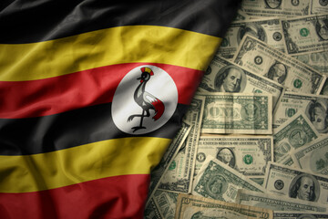 colorful waving national flag of uganda on a american dollar money background. finance concept