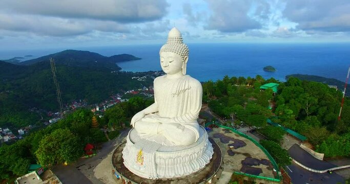 .aerial view Phuket Big Buddha is one of the island most important and revered landmarks in Phuket 360 degree view on Phuket big Buddha viewpoint. .blue sky blue sea and green forest background..