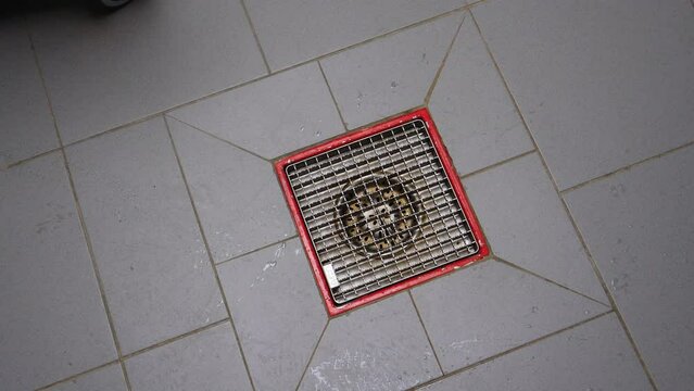A drain for water on the floor of a professional kitchen, restaurant, school, factory, or canteen - slow rotation above 4k UHD