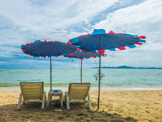 chairs under umbrellas sea view
