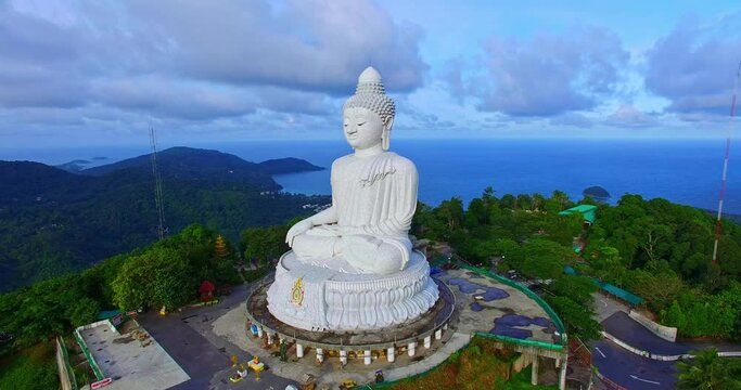 .Aerial photography scenery blue sky and blue ocean behind Phuket white big Buddha..Phuket white big Buddha is the famous landmark in Phuket..beautiful blue sky blue sea and green forest background.
