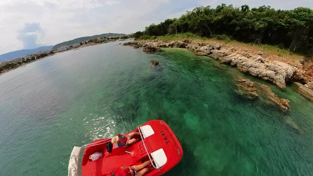 Drone view of a couple embarking on a delightful Pedal Boat trip around the Ksamil Islands, eager to explore the captivating beauty of Ksamil archipelago of Albania.