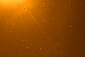 Soap bubbles in the orange sky. Beautifully iridescent balls of soap foam in the air with the rays of the sun