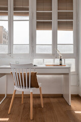 Sunny corner for work: Home office with wood furniture and window view