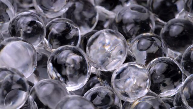 Colorless hydrogel balls closeup. Hydrogel balls moving, macro shot.