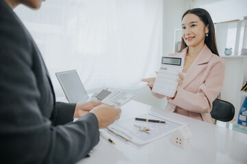 Fototapeta premium Real estate agent and customer discussing for contract to buy, get insurance or loan real estate or property.