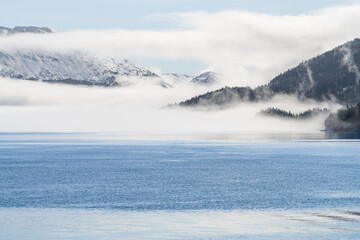 Fog on the mountains and sea in Passage Canal, Whittier, Alaska USA