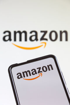 Amazon logo online marketplace ecommerce on a mobile phone and computer screen
