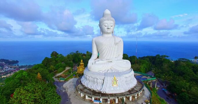 .Aerial photography scenery blue sky and blue ocean behind Phuket white big Buddha..Phuket white big Buddha is the famous landmark in Phuket..beautiful blue sky blue sea and green forest background.