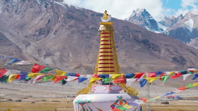 Closeup shot of stupa in front of snow covered Himalayan mountain peaks at Padum in Zanskar Valley, Ladakh, India. Stupa in front of the Himalayas. Buddhist stupa in the middle of mountains in Zanskar