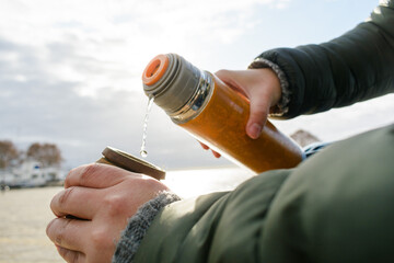 close-up female hands preparing mate outdoors