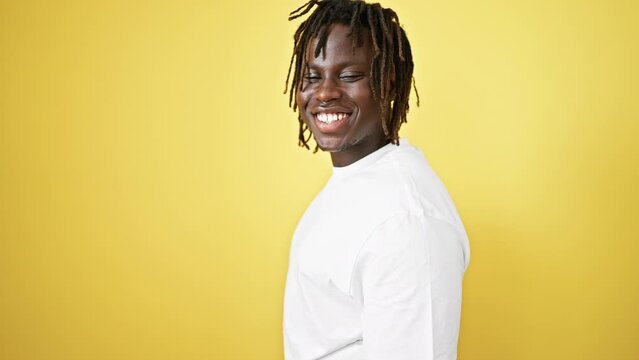 African american man smiling confident standing over isolated yellow background