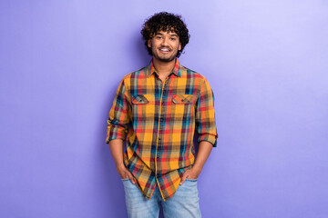 Obraz premium Photo of young funny satisfied guy wear trendy shirt hands pockets denim jeans posing model confidence isolated on purple color background