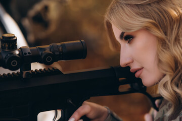 Close-up of camouflage tape on a sniper rifle and scope. A female sniper. - obrazy, fototapety, plakaty