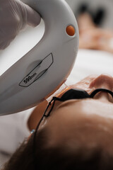 Phototherapy, photorejuvenation, IPL in a beauty salon. Care for a woman's face.