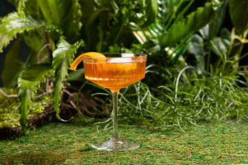 Aperol spritz cocktail in a crystal glass on a tropical background