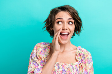 Photo of pretty cheerful lady hand near open mouth look communicate empty space ad isolated on emerald color background