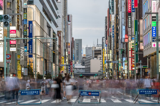 Tokyo, Chuo-Ku, Ginza - August 13, 2017 : Motion blurred people walking along shops at Chuo Dori Street in Ginza district.