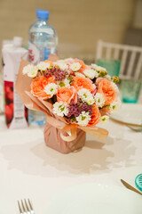 Bouquet of flowers on the served table. 
