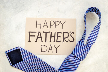 Fototapeta na wymiar Postcard concept flatlay for Happy Fathers day with blue tie
