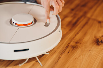 Vacuum Robot cleaning at home. Robot vacuum cleaner in the modern home. Smart cleaning...