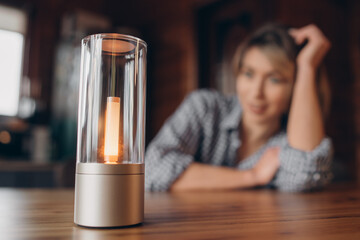 A table smart lamp, a woman on a blurred background.