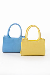 Stylish and colorful woman handbags on isolated white background.