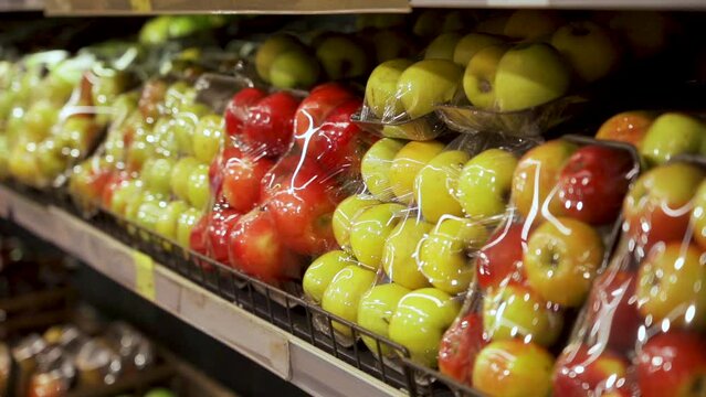 Vacuum-packed fresh fruit on the store shelf in the supermarket