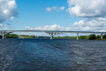 Dubna, Russia, June 3, 2023. High reinforced concrete bridge across the river against the sky.